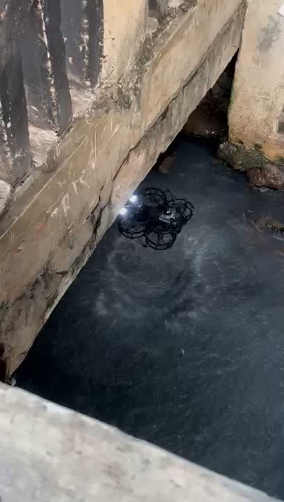 Skyline flying through a narrow culvert over water
