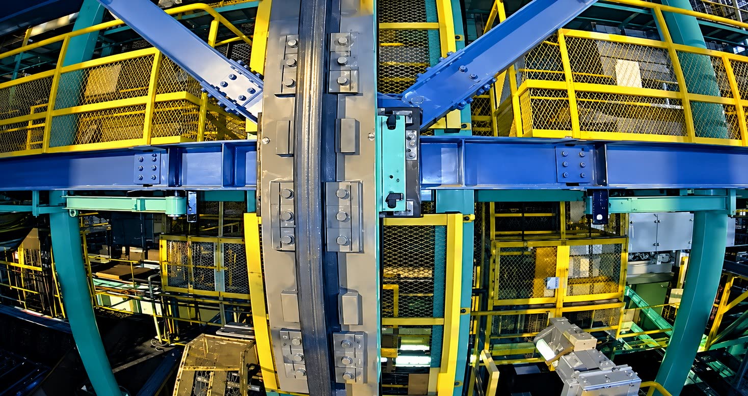Close-up camera view of steel rail structure with bolts