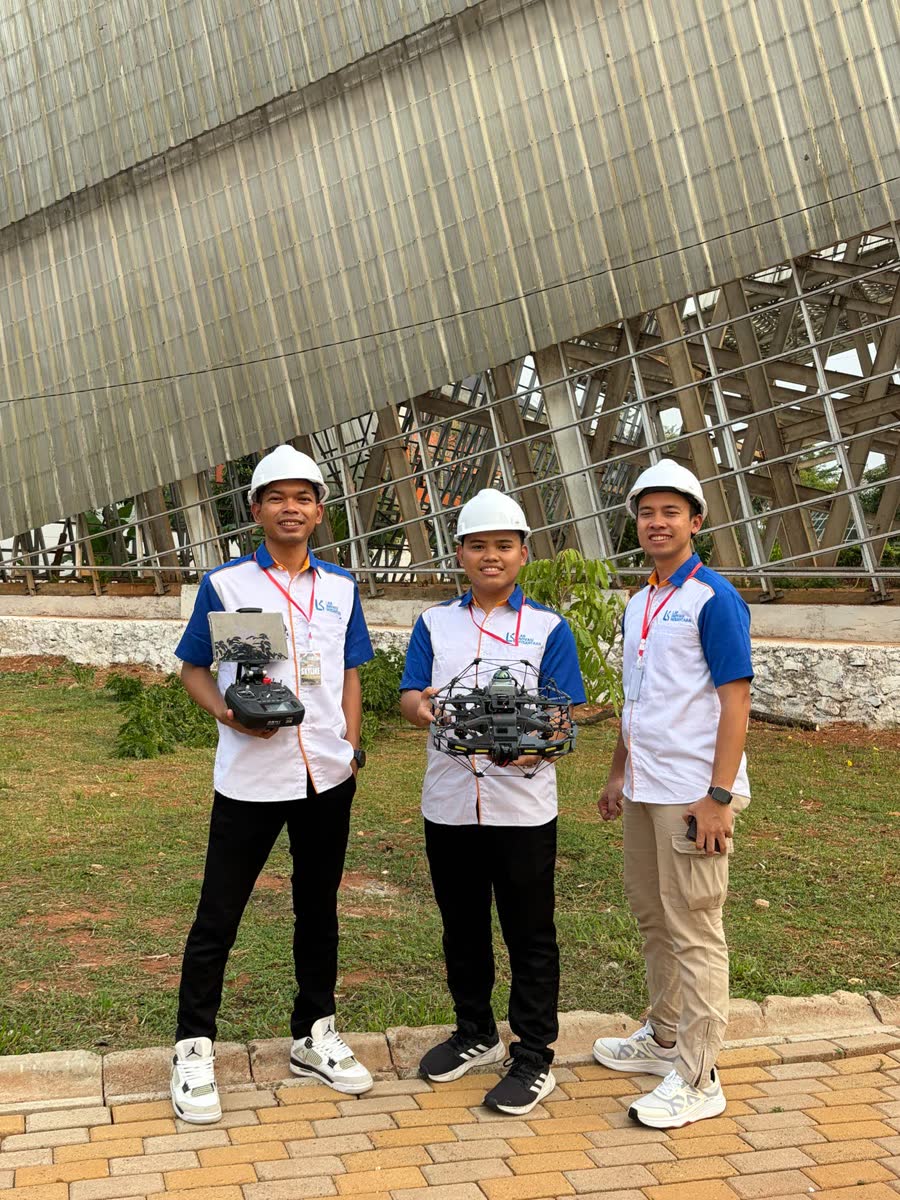 The Skyline engineering team holding the drone and controller